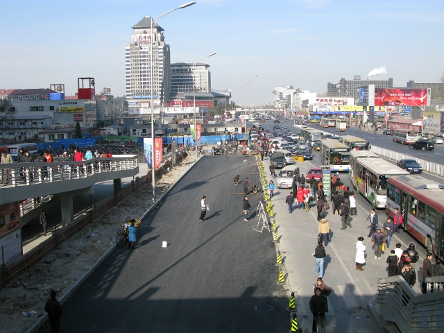 This is a view of Zhongguancun DaJie (中关村大街) at about 1:00 pm looking north.  It is acually pretty dead.  Notice the skies, the mass of bikes on the left side of the photo, and the lack of cars traveling north.