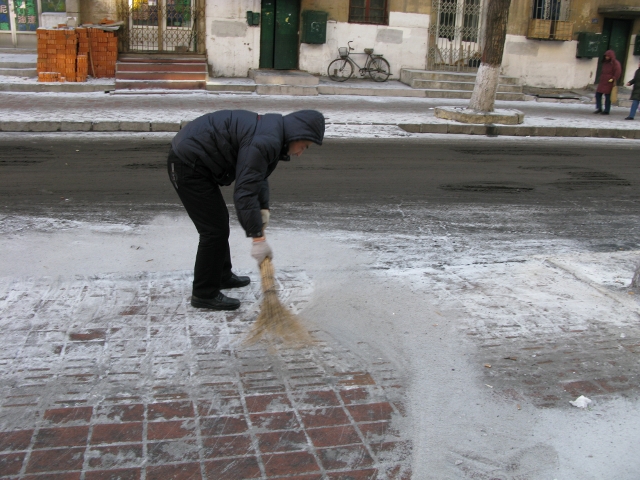 This man was sweeping the snow with a broom about two feet long. I could not resist photographing him.  He caught me!